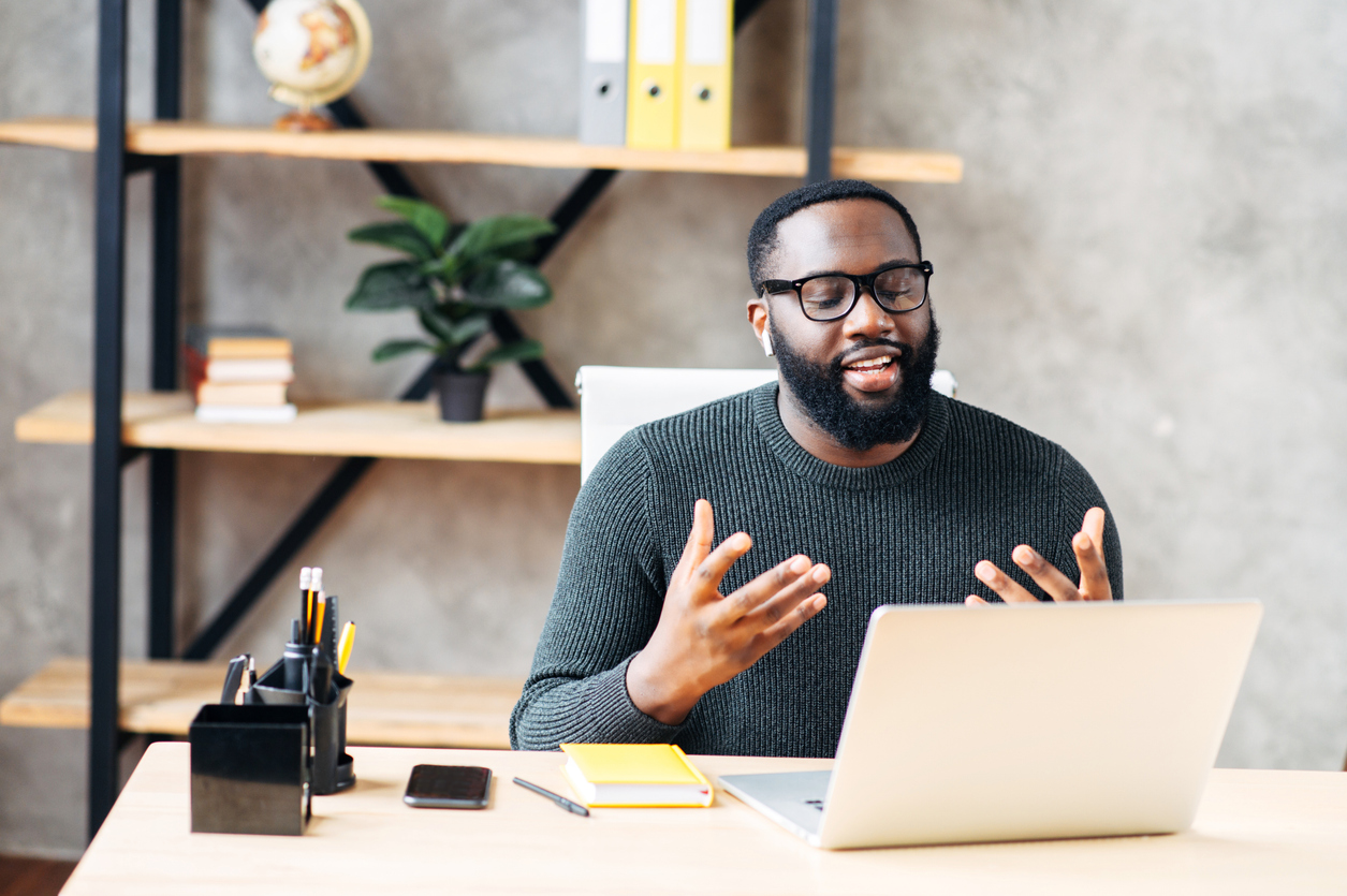A man talking with his counselor during an online counseling session
