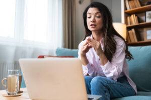Woman speaking with a biblical counselor during an online video session from home