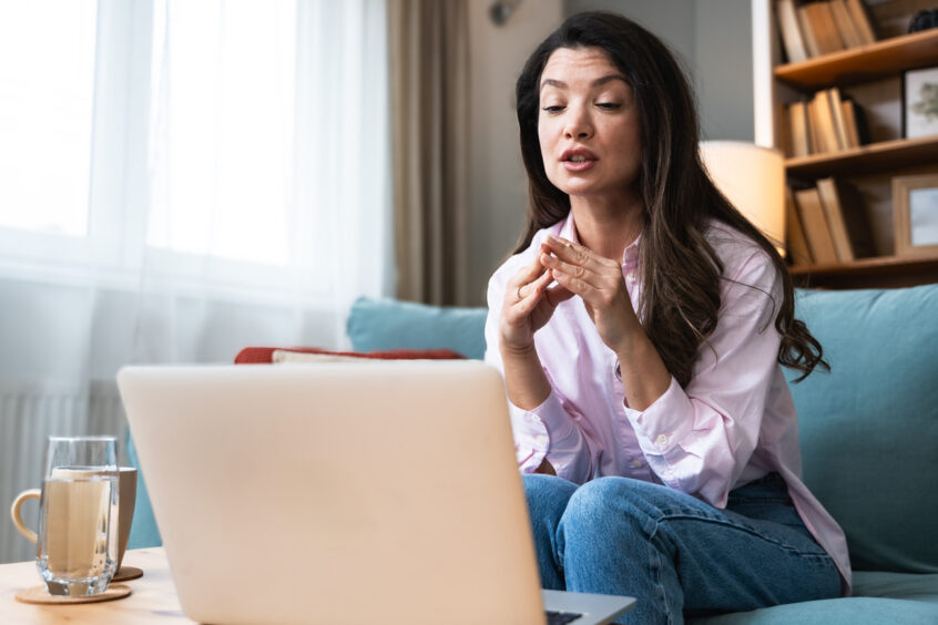 Woman speaking with a biblical counselor during an online video session from home